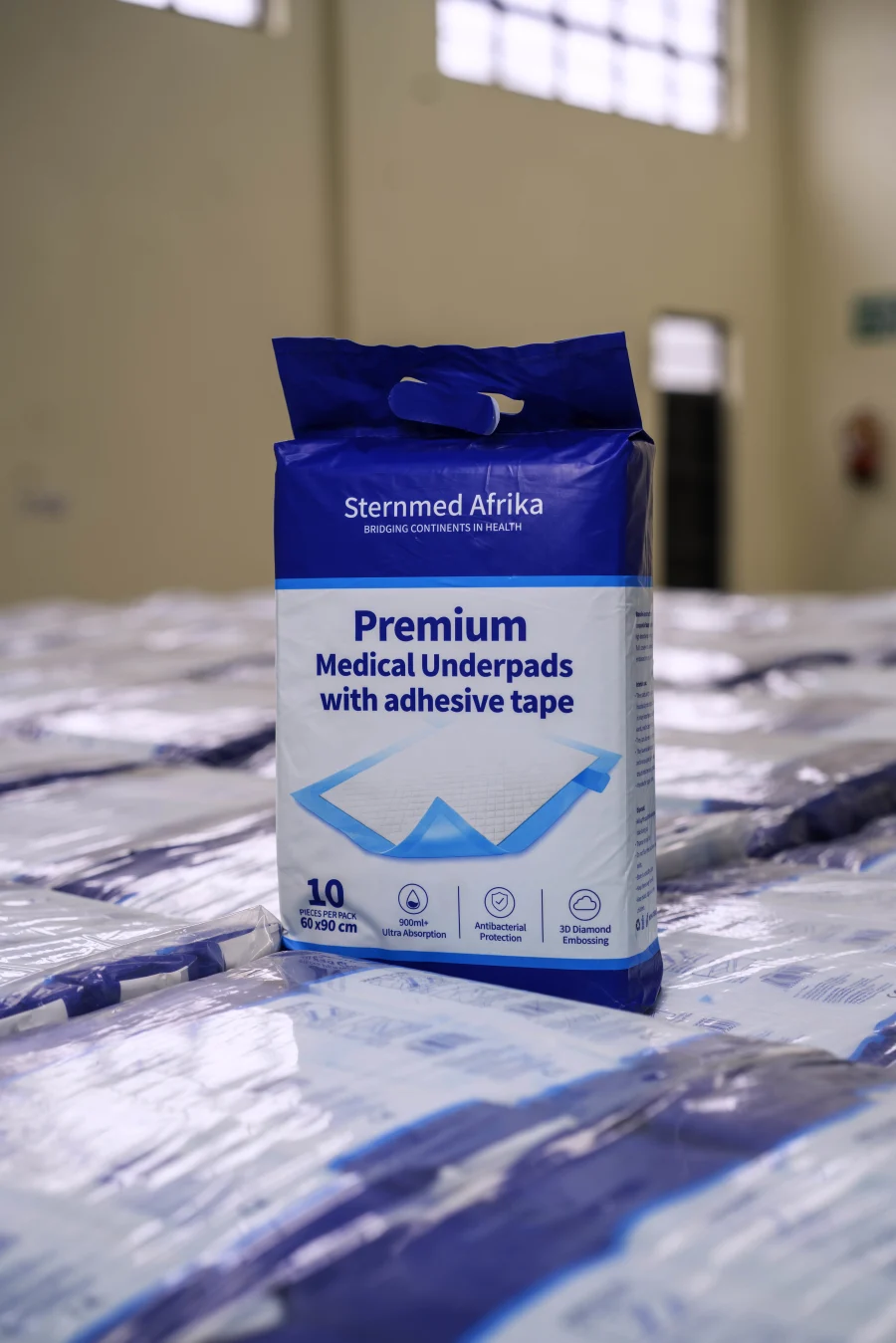 A packet of Sternmed Premium Medical Underpads on stacked bales in the Nairobi store